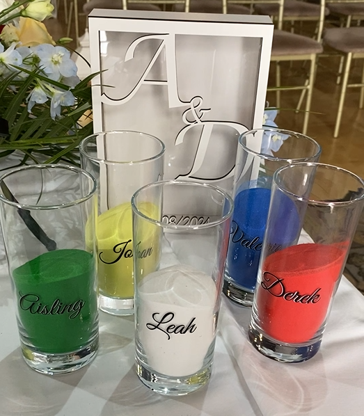 Five different coloured sands ready to be poured in the Sand Ceremony at a Humanist Wedding.